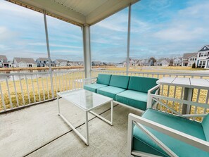 Screened porch with views of the pond, community beach, gazebo and firepits