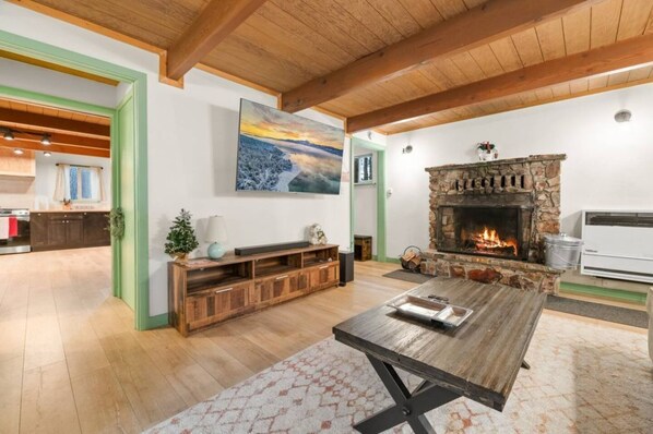 "Find warmth and comfort in our rustic living room, where the stone fireplace and wooden beams create a perfect retreat.
