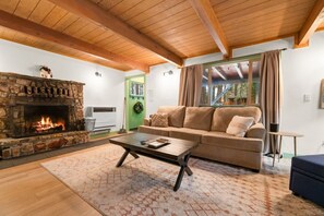 "Find warmth and comfort in our rustic living room, where the stone fireplace and wooden beams create a perfect retreat.