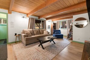 "Find warmth and comfort in our rustic living room, where the stone fireplace and wooden beams create a perfect retreat.