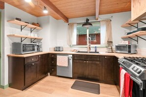 Cook and dine in style in our warm and welcoming kitchen, where rustic wooden beams and a spacious dining table invite shared moments and culinary creativity.