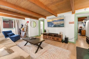 "Find warmth and comfort in our rustic living room, where the stone fireplace and wooden beams create a perfect retreat.