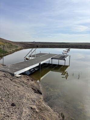 24' x 12' non floating stable dock with bench and stairs to the water.  