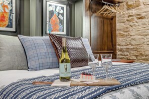 Rest easy in this king bedroom with soft linens, a TV, and a private bathroom