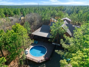 Escape to our modern retreat nestled among the whispering pines. Unwind by the private, circular pool on the sun-soaked deck, or gather around the fire pit for an evening of stories and stargazing.