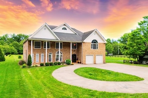 The front of the house features ample parking and inviting spots to relax and unwind.