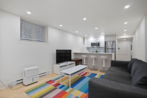 Enjoy the best of both comfort and convenience, complete with a cozy sofa, Smart HD TV for streaming, and an easy flow to the kitchen
