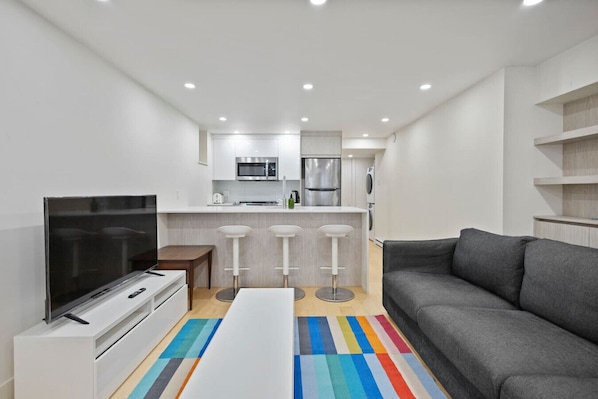 Step into a fresh, modern space where clean lines and cheerful touches set the tone for a laid-back stay