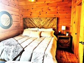 A king bed with a new, soft mattress and brand new linens, awaits you.