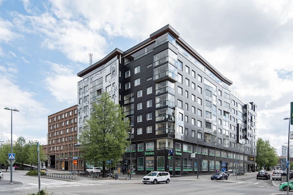 Property building. The apartment is located right next to Tampere Railway station.
