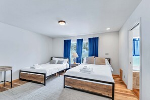 Bedroom 1: 2 Queen beds, en-suite bathroom with jetted tub, standing shower, workspace