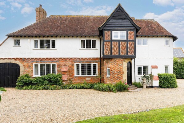 Step into your own countryside retreat with this beautiful traditional home. The warm brick and timber details make this a picture-perfect holiday stay.