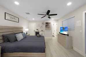 A bright and spacious bedroom with a plush king-sized bed, stylish décor, and soft lighting. Relax in comfort with ample space to unwind.