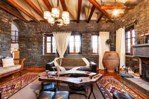 Relax and unwind by the fireplace, surrounded by unique decor and a cozy ambiance.