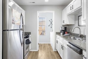 The open, airy kitchen offers ample storage & every home comfort
