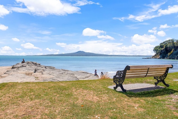 Sit on the park bench and enjoy the stunning view over to Rangitoto Island.
