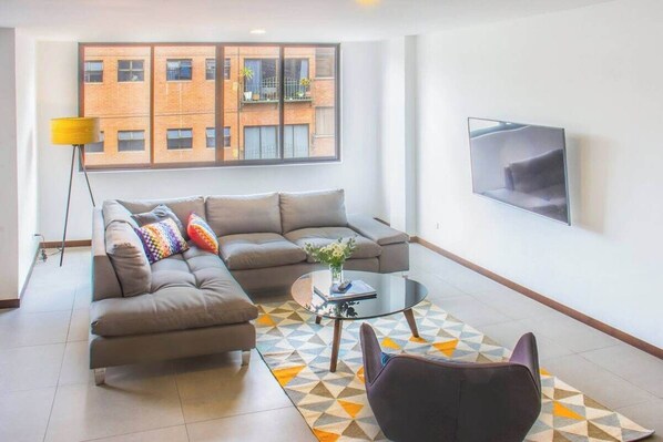 Living room with 55" SmartTV that connects to Netflix. Since taking the picture, a big curtain has been installed in the window offering increased privacy.