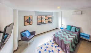 Wide angle pic of bedroom # 2 with A/C, TV and blackout curtains.