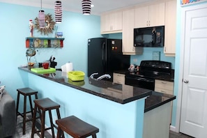 A well-decorated kitchen with cabinets for your food storage.