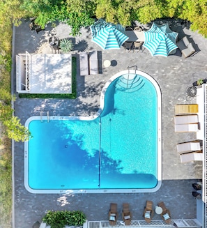 Relax by the pool with sun loungers and shaded seating areas for comfort.