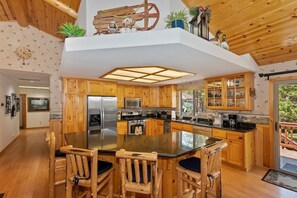 Cook in style with our modern kitchen, featuring wooden cabinets and stainless steel appliances.