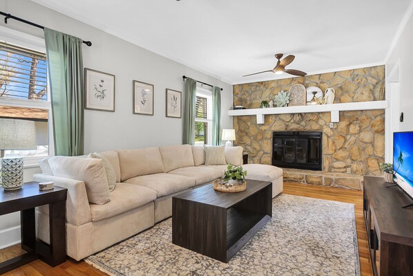 TV room with spacious sectional and smart TV. Fireplace in inoperable. 