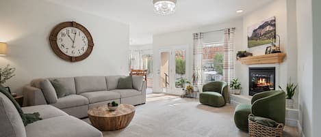 Step into a comfy and stylish primary living room with fireplace, and plush sectional