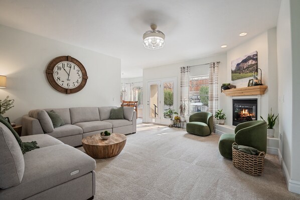 Step into a comfy and stylish primary living room with fireplace, and plush sectional