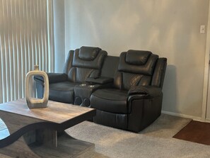 Relaxing leather recliners with blue tooth speakers.