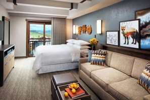 Guest room features a king bed and sitting area that converts into a queen sleeper sofa for two.