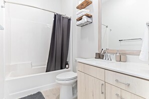 You feel a sense of calm as you enter the bathroom, where the thoughtful design and high-quality materials create a serene environment.