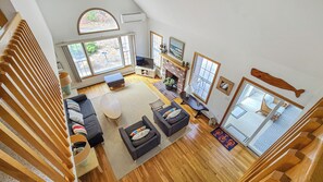 Looking down from the second floor landing at the roomy main living area below