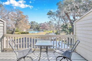 - Enjoy coffee or cocktails from your private balcony overlooking the pond and trees
- Outdoor bistro set offers the perfect space for a quiet morning or romantic sunset
- Scenic views of the water and pool area create a peaceful retreat setting