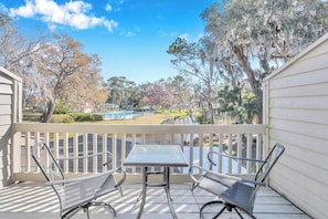 - Enjoy coffee or cocktails from your private balcony overlooking the pond and trees
- Outdoor bistro set offers the perfect space for a quiet morning or romantic sunset
- Scenic views of the water and pool area create a peaceful retreat setting