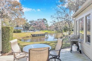 - Relax outdoors on this peaceful deck with a dining table, cushioned chairs, and BBQ grill
- Overlooks a tranquil pond with Spanish moss trees and gentle golf views beyond
- Perfect for outdoor meals, evening wine, or watching nature in comfort