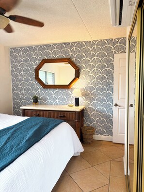 The bedroom has a large dresser and an additional dresser inside of the closet. 