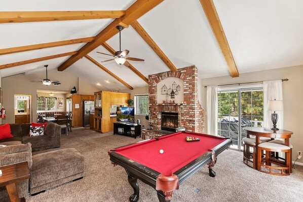 The cabin's living room area comes with a pool table.
