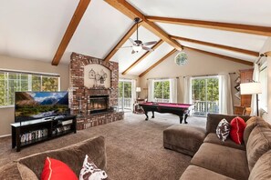 There is a nice sitting area in the cabin's ;living room by the cozy fireplace and large screen TV.