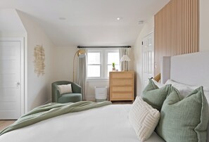 King bed, plush bedding, cozy reading nook, dresser - perfect, relaxing retreat