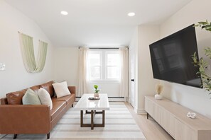 Cozy sofa, marble coffee table, 65" smart TV - relax in style.