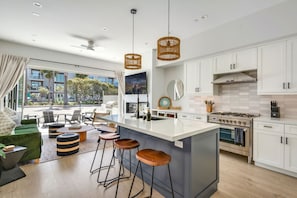 1st Level: Kitchen and living room with doors that open up to a private patio, fire pit and BBQ