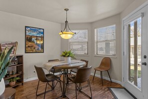 dining area surrounded by windows to the back