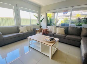 Main living area with Smart TV, reading books, games, WII console.