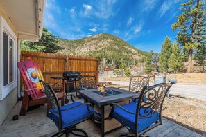 Unwind on the shared patio with breathtaking mountain views – featuring a fire pit table, comfortable seating, and a grill for outdoor dining in a serene setting.





