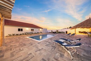 Refreshing outdoor pool with lounge chairs for sun-soaked relaxation.