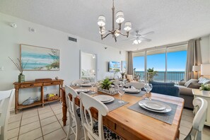 Indoor-outdoor living seamlessly blends in this dining space, with direct access to a balcony overlooking the stunning ocean.