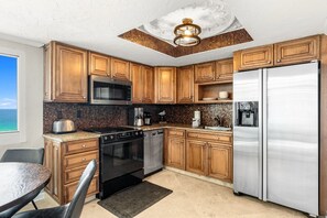 The kitchen has a beautiful warm mosaic backsplash and granite that is the perfect complement to the honey-colored cabinets.
