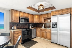 The kitchen has a beautiful warm mosaic backsplash and granite that is the perfect complement to the honey-colored cabinets.