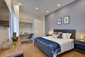 Bedroom 2 - also spacious, with high ceilings, smart TV, work desk and access to private bathroom.