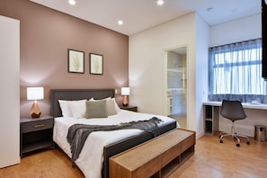Big bedroom with high ceilings, work space and access to private bathroom.